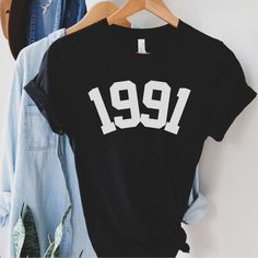 1991 Birthday Year Number Shirt for Women, Womens 30th Birthday T-Shirt, Cute Birthday Gift, Awesome 30th, 30th in 1991 Shirt For Men Women This updated unisex essential fits like a well-loved favorite. Super soft cotton and excellent quality print makes one to fall in love with it over and over again..: 100% Airlume combed and ringspun cotton (fiber content may vary for different colors).: Light fabric (4.2 oz/yd² (142 g/m²)).: Retail fit.: Tear away label.: Runs true to size The 1975 Shirt, 55th Birthday, Number Shirt, Projets Cricut, Birthday Gift For Women, Birth Year, Shirt Fits, College Fashion, Shirt For Women