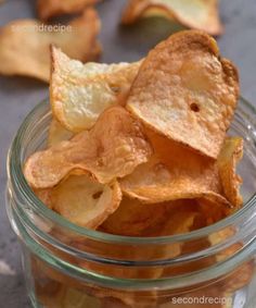 a glass jar filled with chips on top of a table