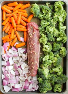 an assortment of vegetables and meat in a tray