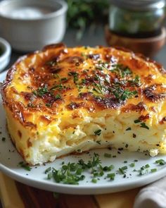 a white plate topped with a cheesy dish on top of a wooden table