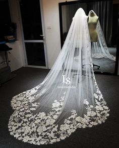 a wedding veil with white flowers on it