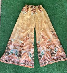 "Vintage sheer floral print palazzo pants. These pants are so fabulous! They almost look like they could have been homemade. They don't have any tags anywhere on them. They fit like an extra small. They feel like a polyester, cotton, and nylon blend. They have an elastic waist. No Pockets. They're in great condition.  Measurements laying flat Across the waist 11\" (22\" total) Elastic waist stretches to about 16\" (32\" total) Top to bottom 37\" Items are shipped out within 1-2 business days. If Bohemian Floral Print Bottoms For Summer, Bohemian Summer Bottoms With Floral Print, Bohemian Floral Print Summer Bottoms, Full Length Floral Print Wide Leg Pants For Summer, Summer Floral Print High-waisted Wide Leg Pants, Summer High-waisted Floral Print Wide Leg Pants, Bohemian Floral Print Bottoms For Spring, Vintage Spring Festival Pants, Vacation Floral Print Wide Leg Pants