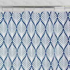 a blue and white shower curtain hanging from a metal rod