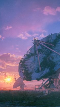 a very large satellite dish sitting on top of a grass covered field under a purple sky