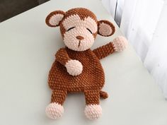 a knitted monkey sitting on top of a table