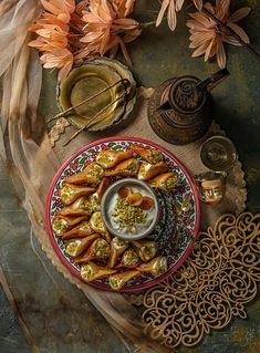 a plate full of appetizers on a table next to other dishes and decorations