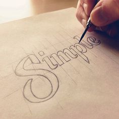 someone is writing the word summer on a piece of paper with a pencil in their hand