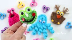 someone is holding up some crocheted items to make them look like they are smiling