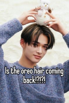 a person holding a stuffed animal over their head with the caption is the oreo hair coming back?