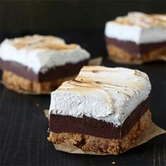 three pieces of chocolate and marshmallow dessert sitting on top of eachother