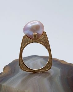 DEN1902 One of a kind baroque pearl 14k yellow gold ring. We found a dealer once with a most remarkable inventory. She had everything, matched strands, golden, Tahitian black, Akoya and a small ziplock bag containing a handful of these wonderful mauve baroque freshwater pearls. Each one was unique, the off-round qualities and the lovely depth of nacre suggesting such beautiful possibilities. This ring is the first of a line of designs using this treasure trove of special pearls. The idea in this Golden Pearl Ring, Pearl Ring Designs Unique, Chandelier Jewelry, Proposal Rings, Jewellery Women, Jewelry Aesthetic, Ice Box, Over Size, Keshi Pearls