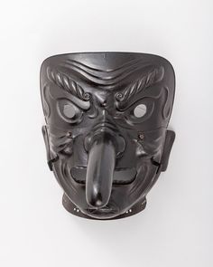 a black mask with an open mouth on a white background