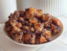 a white bowl filled with food on top of a table