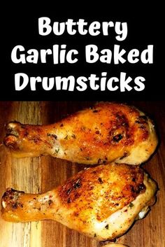 two chicken drums sitting on top of a wooden cutting board with the words, buttery garlic baked drumsticks