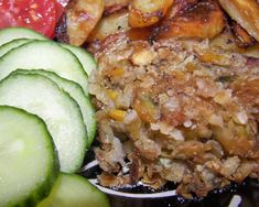 a close up of food on a plate with cucumbers