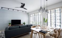 a living room filled with furniture and a flat screen tv mounted to the side of a wall