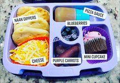 a purple lunch box filled with different types of food and words on the trays