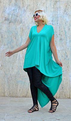 Extravagant teal top made of the finest viscose, very playful and loose, perfect for summer. The bright teal and the long tail will for sure steal the spotlight on the urban scene in this season. Material: 95% Viscose, 5% Elastane Care instructions: Wash at 30 degrees The model in the picture is size S. Can be made in ALL SIZES. If you have any other specific requirements, do not hesitate to contact me! I DO NOT CHARGE EXTRA MONEY for custom made items. All you need to do is send me your measure Drapey Asymmetrical Summer Tops, Summer Asymmetrical Viscose Top, Asymmetrical Viscose Top For Summer, Asymmetrical Green Summer Blouse, Chic Green Top With Asymmetrical Hem, Green Blouse With Asymmetrical Hem For Summer, Green Viscose Short Sleeve Tops, Green Asymmetrical Stretch Top, Asymmetrical Green Stretch Top