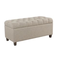 a large beige bench with buttons on the top and legs, in front of a white background