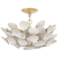 a white and gold chandelier hanging from a ceiling fixture with leaves on it