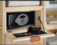 an open microwave oven sitting on top of a wooden shelf