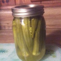 pickles in a jar sitting on a table