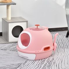 a pink cat house sitting on top of a rug