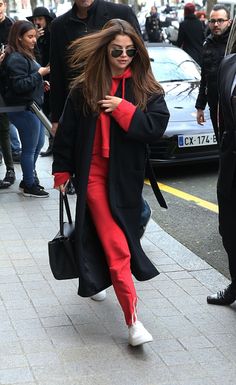 a woman with long hair walking down the street