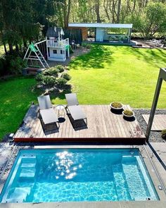 an above ground swimming pool with lounge chairs and a deck in the middle of it