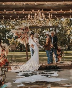 a couple getting married under a wooden structure