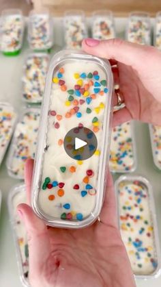 a person holding up a container with sprinkles on it