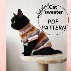 a black cat wearing a sweater sitting on top of a scratching post in front of a white wall