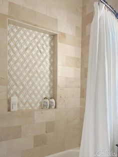 a bath room with a tub and a mirror on the wall next to a shower curtain