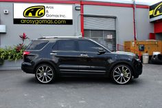 a black suv parked in front of a building