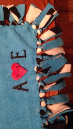 a blue towel with the words i love my mom on it and a red heart