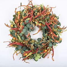 a wreath with orange and green leaves on it