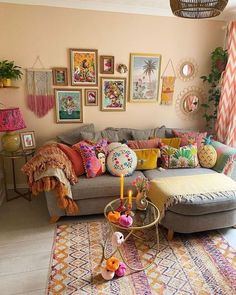 a living room filled with furniture and pictures on the wall