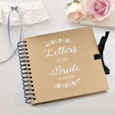 a notebook with the words letters to the bride written on it next to a flower