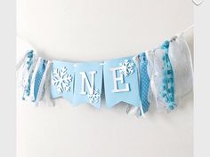 a blue banner with white snowflakes and the word ne on it hanging from a wall