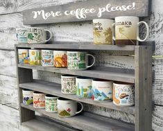 coffee mugs are lined up on the shelves in front of a wood paneled wall