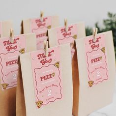 small paper bags with pizza tags attached to them