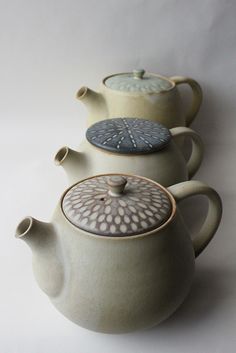 three teapots are stacked on top of each other