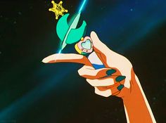 a hand holding an object in the shape of a star and pointing to it with its finger