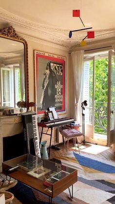 a living room filled with furniture and a piano in front of a large mirror on the wall