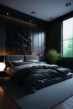 a large bed sitting next to a window in a room with black walls and wooden flooring