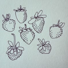 a drawing of strawberries with bows on them