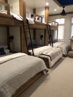 a room with bunk beds and pillows in it