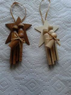 two wooden ornaments are sitting on a white tablecloth, one is shaped like an angel and the other has a star