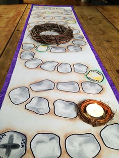 a table runner with a candle on top of it and a bird's nest in the center