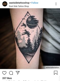 a black and white tattoo on the arm of a person with trees in the background